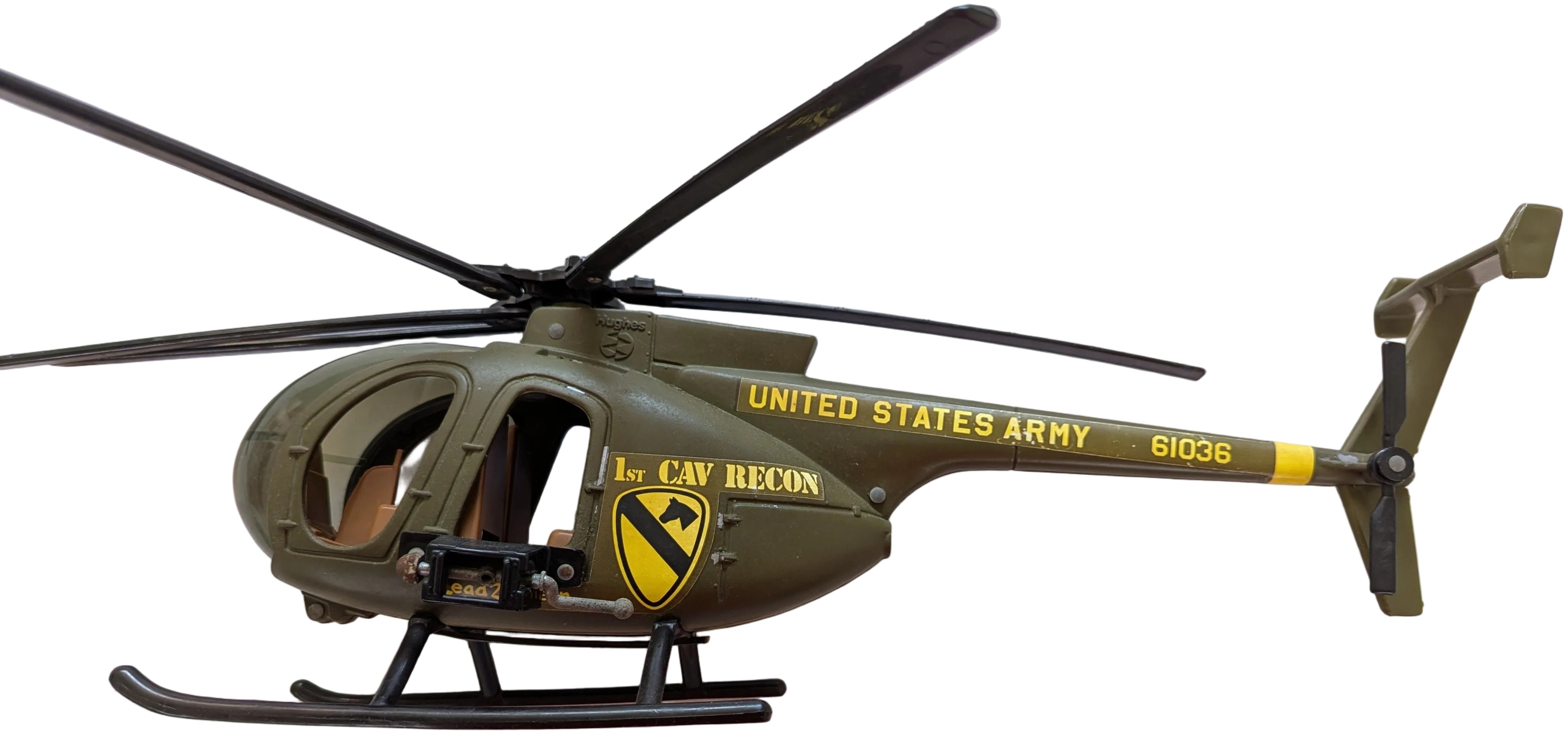 A toy model of a United States Army 101st Air Recon Helicopter, featuring olive green and black with yellow lettering and insignia, photographed against a light-colored background.