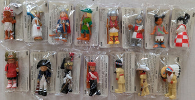 A set of fifteen small packaged toy Mondotime figurines arranged in two rows on a white background. Each figure is sealed in clear plastic packaging with a printed card insert.