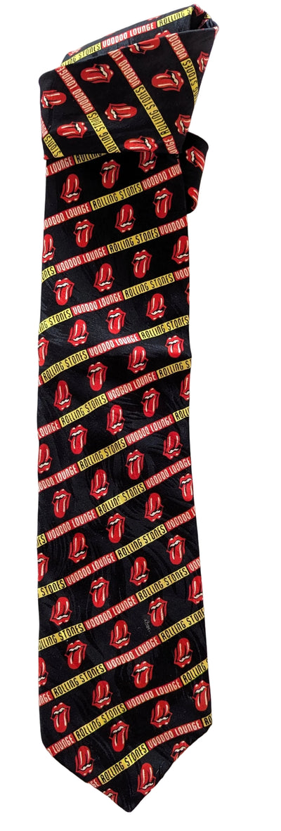 A black necktie featuring a repeating pattern of the Rolling Stones logo and diagonal red, yellow, and green stripes.
