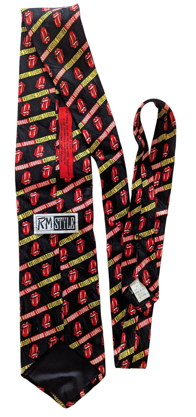A black necktie with a repeating red and yellow tongue pattern, featuring a red neck strap and a white 'RM STYLE' brand patch on the back.