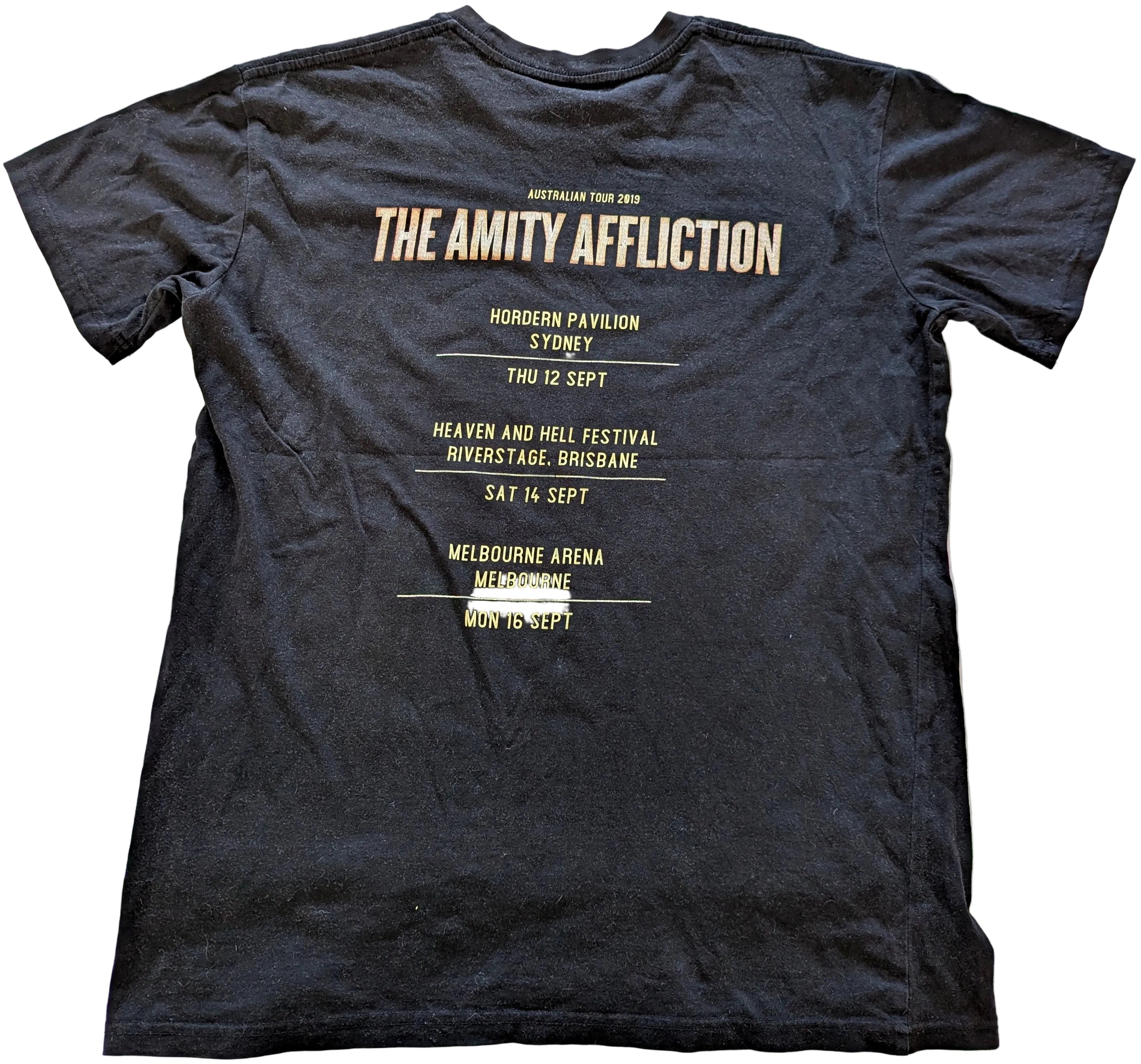 Black t-shirt with 'The Amity Affliction' concert tour details on a white background